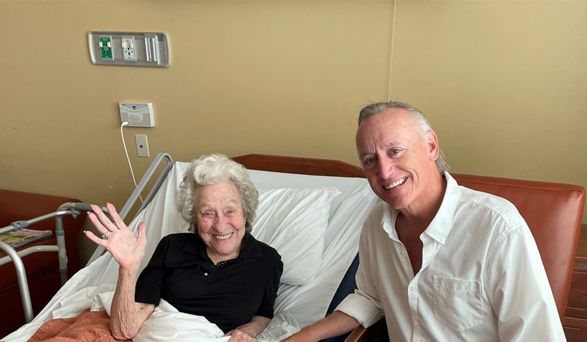 Almost There Senior Care - Brian Backman Sitting with A Senior While She is in Bed